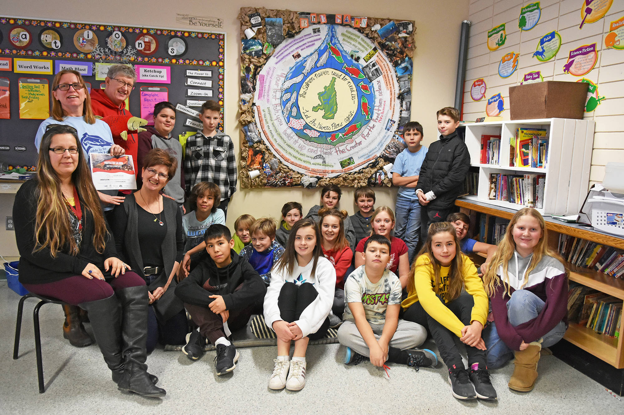 From left, Tara Willard, School District #83 Indigenous education worker, teacher Sue Whitehead, Molly Cooperman and Brenda Melnychuk of The Adams River Salmon Society pose with Grade 6/7 students and their entry into the How Can We Help the Salmon Come Home contest. (Lachlan Labere/Salmon Arm Observer)