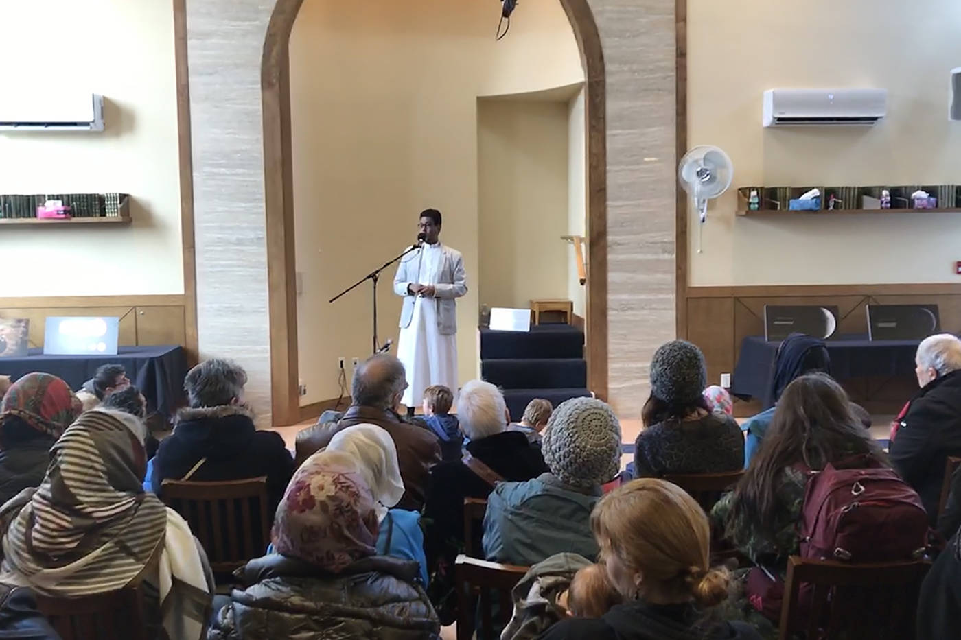 Ismail Mohamed Nur, Imam of the mosque, speaks to the crowd Saturday afternoon during Open Mosque Day. (Keri Coles/News staff)