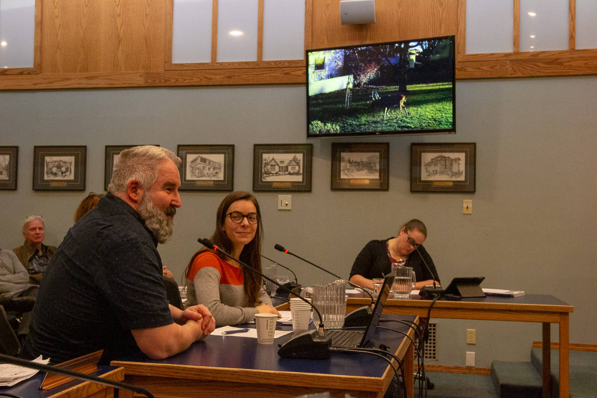 Jason Fisher (left) and Sandra Frey (right) present an Urban Wildlife Stewardship Society report to Oak Bay councillors and community members at a committee of the whole meeting on Feb. 19. (Jesse Laufer/News Staff).