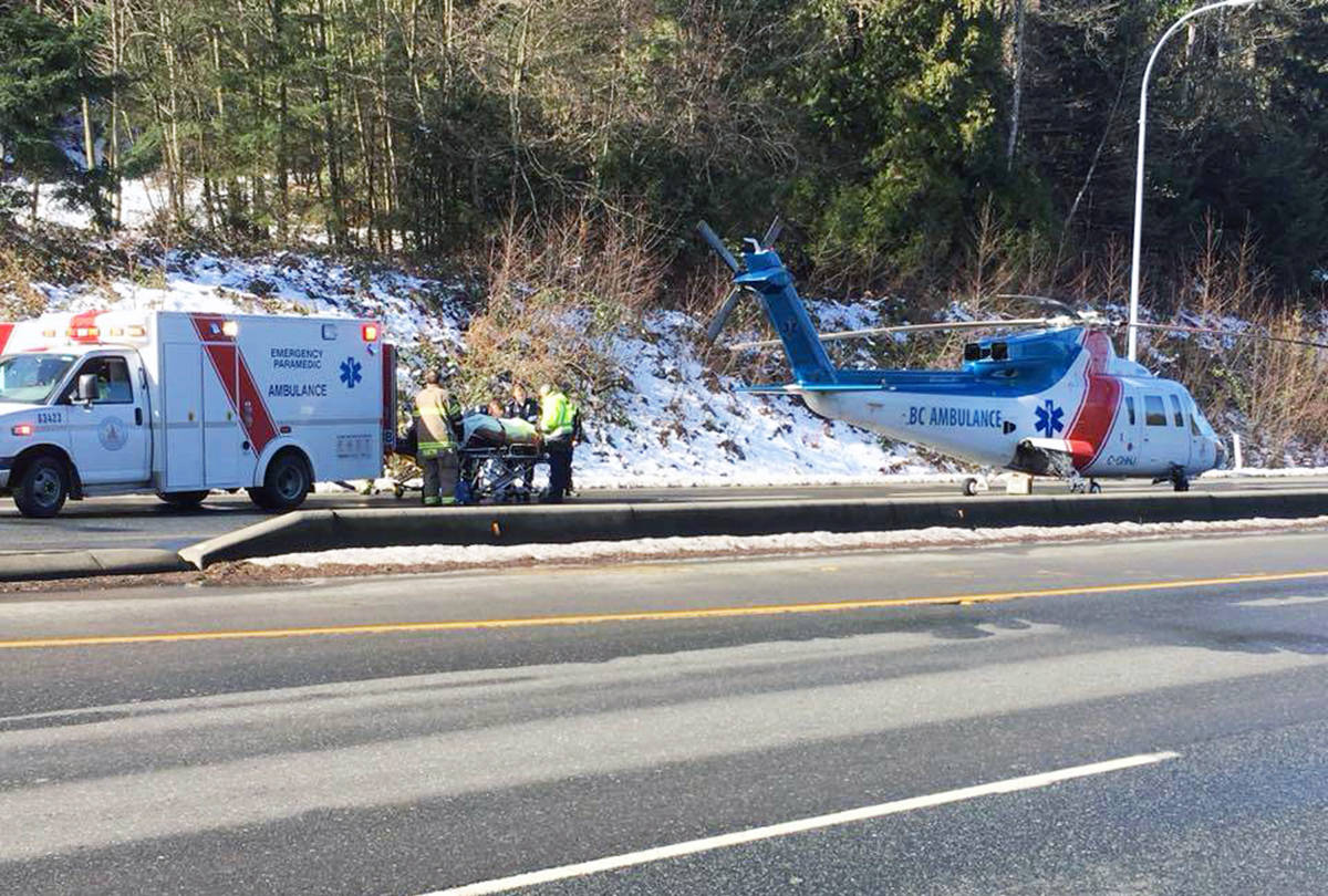 Patient is transported from an ambulance to a waiting helicopter on the Trans-Canada Highway. (Photo by John Mountain)