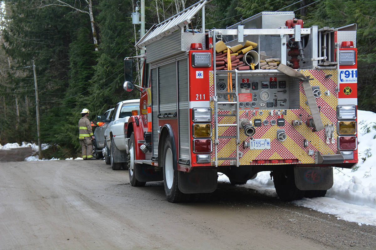 A fire truck and emergency personnel on Steelhead Place in Errington on Sunday, March 3. Two workers were taken to hospital after being pinned after a roof collapse on a nearby property. -Peter McCully photo