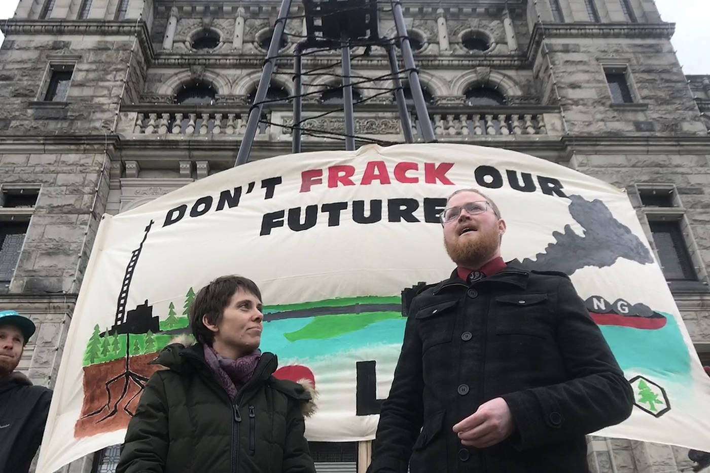 Peter McCartney (right), climate campaigner for the Wilderness Committee, delivers more than 16,000 signatures in support of a provincial ban on fracking to Green Party MLA Sonia Furstenau. (Keri Coles/News staff)