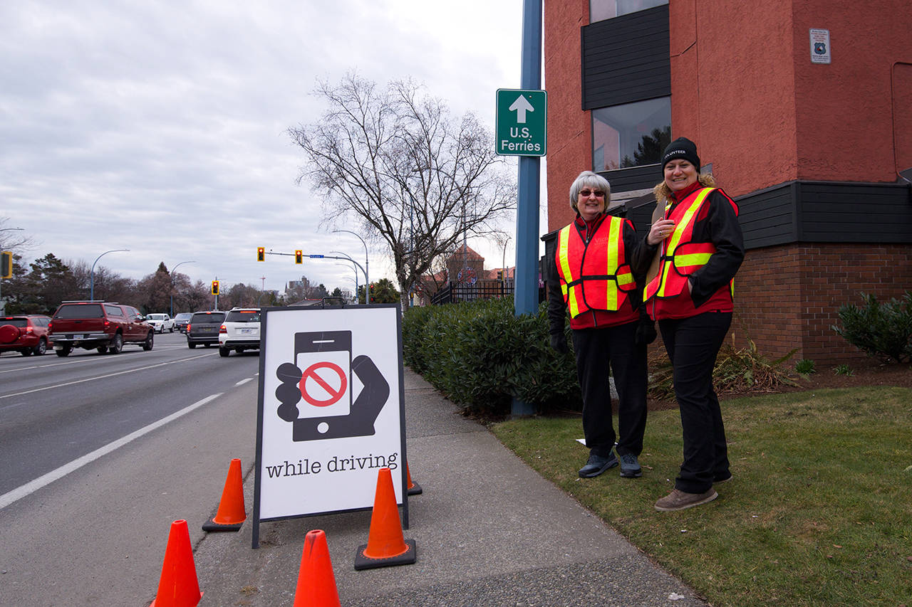 Maryellen Trudeau (left) and Monica Pozzola are volunteers with the Victoria Police Department. They’re helping spread awareness about distracted driving as police forces across the Capital Region crack down on people using cellphones while driving. (Nicole Crescenzi/News Staff)