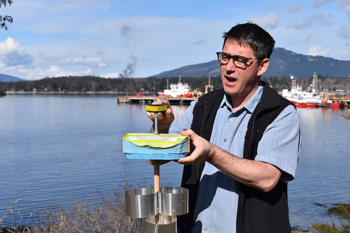 Jon Chamberlain holding a surface drift tracker affectionately known as a Sponge Bob. (Nick Murray/News Staff)