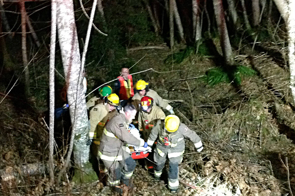 First responders carry a man from the scene of a motor vehicle incident in Oyster River on Thursday night. Photo courtesy Oyster River Fire Rescue