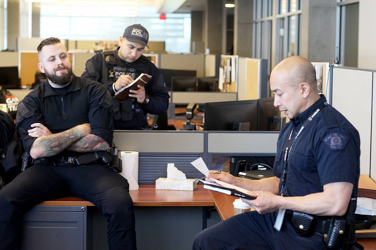 Sergeant Mike Sanchez of Surrey’s Gang Enforcement team (right) briefs the squad before they head out on March 1. Officers Brad Reeves and Harjit Sidhu, on left. (Photo: Amy Reid)
