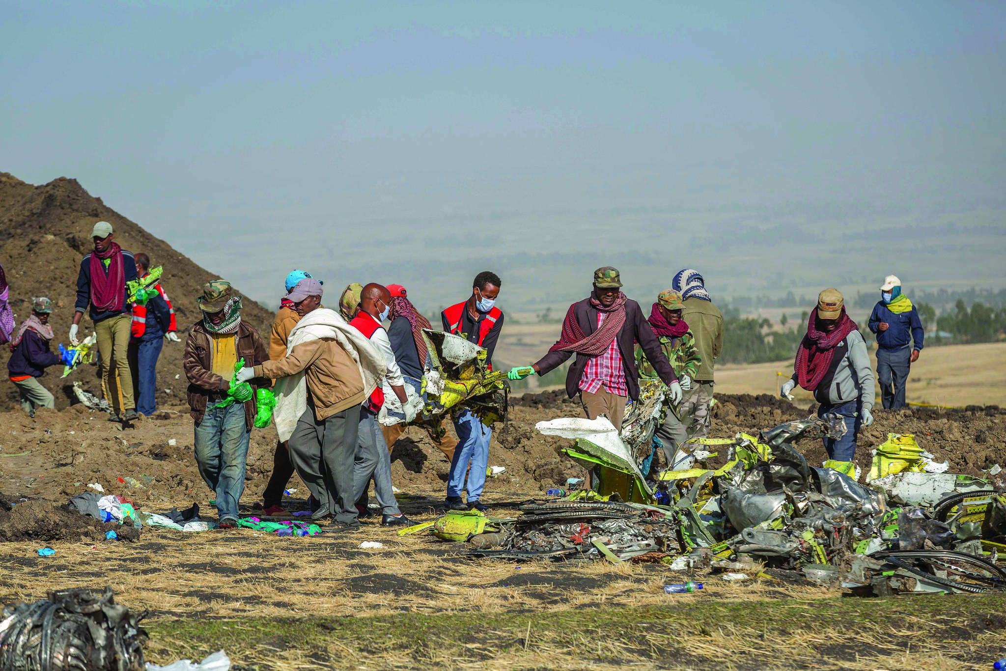 Rescuers work at the scene of an Ethiopian Airlines flight crash near Bishoftu, or Debre Zeit, south of Addis Ababa, Ethiopia, Monday, March 11, 2019. A Vernon business owner was among those who died in the crash. (AP Photo/Mulugeta Ayene)