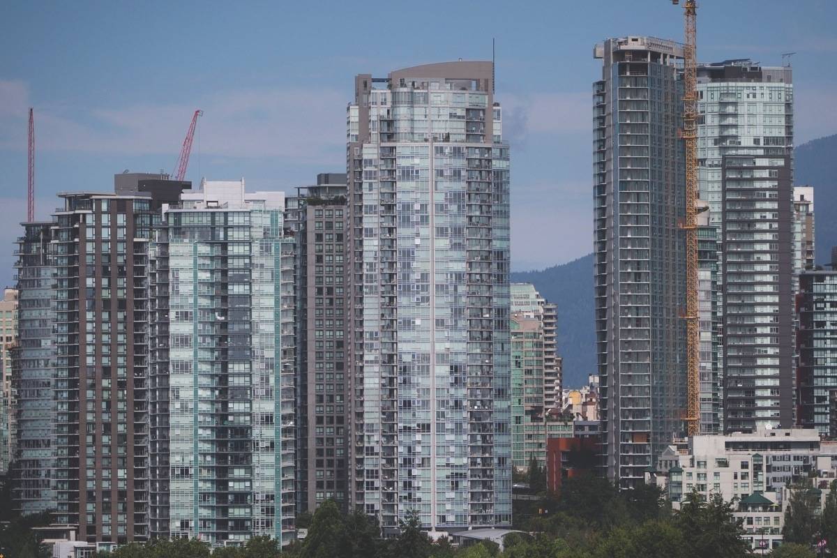 Condo towers, including one under construction, right, are seen in downtown Vancouver. (THE CANADIAN PRESS)