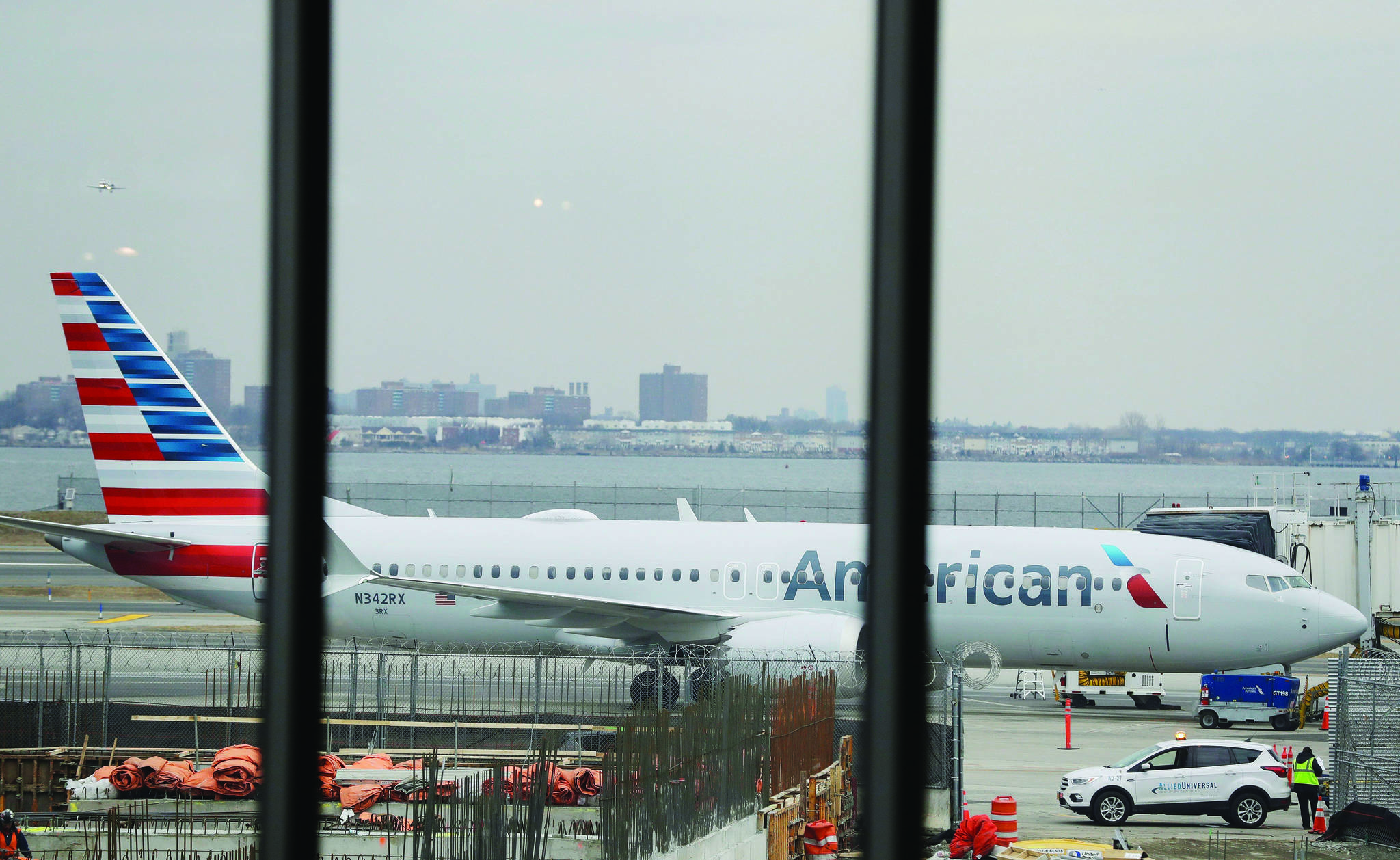 An American Airlines plane sits at a boarding gate at LaGuardia Airport Wednesday, March 13, 2019, in New York. The Federal Aviation Administration issued an emergency order Wednesday grounding all Boeing 737 Max aircraft in the wake of a crash of an Ethiopian airliner that killed 157 people, a reversal for the U.S. after federal aviation regulators had maintained it had no data to show the jets are unsafe. (AP Photo/Frank Franklin II)
