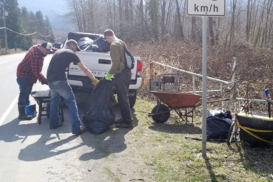 Volunteers load trash from the Vedder River into pickup trucks on Sunday. Submitted photo