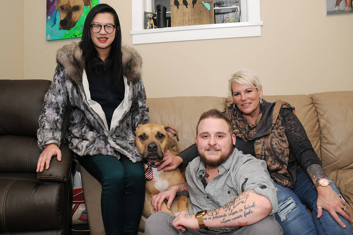 Helen Poon, left, and Rhonda Maczulat, right, combined to donate $1,000 to Jessi Howden’s fundraiser for his emotional support dog Zeus’s surgery.                                SUSAN QUINN PHOTO
