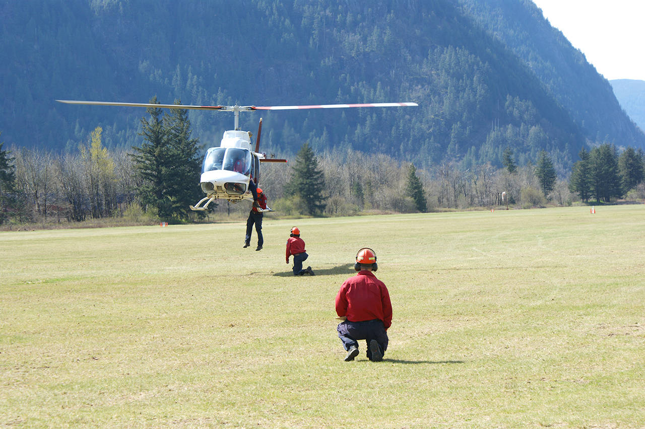 Kevin Cochrane of BC Wildfire Services looks on as firefighters practice their hovering heli-exit strategies.  Sarah Gawdin/Hope Standard