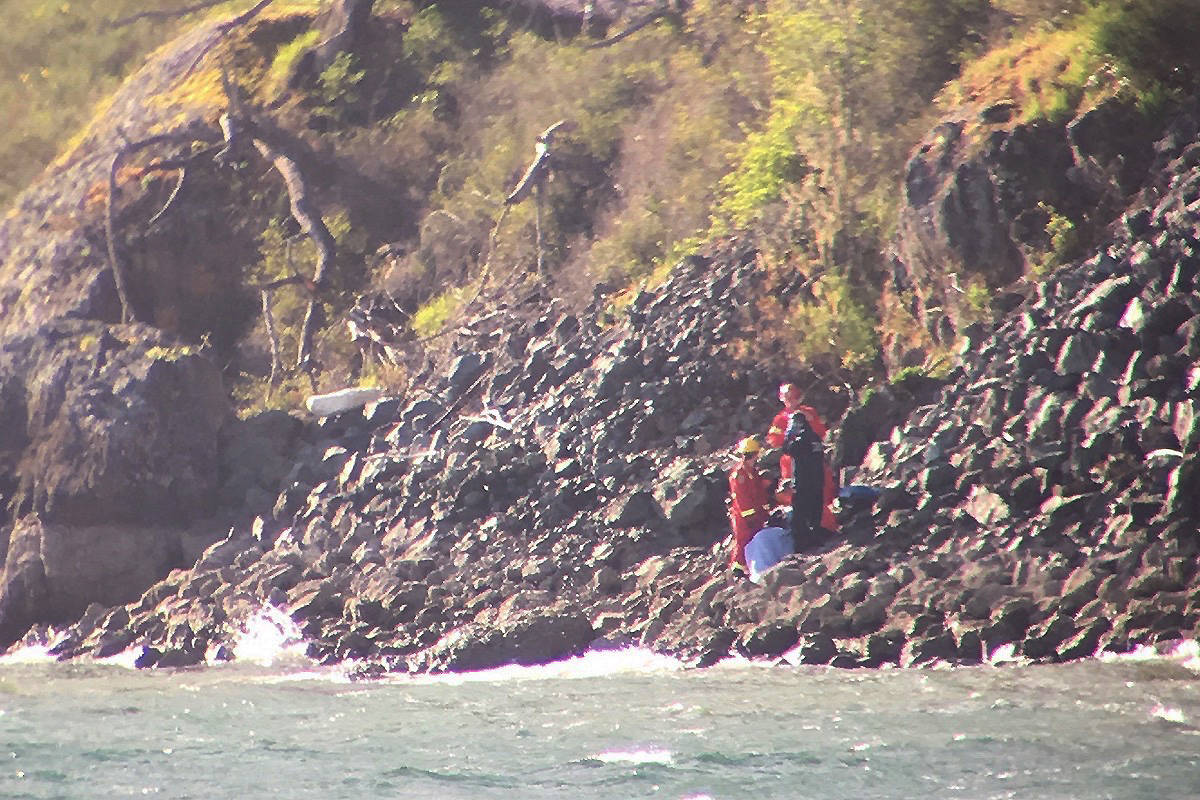 The rocky escarpment made it difficult to get the boating accident victim up to the waiting ambulance. (Kara Arden)