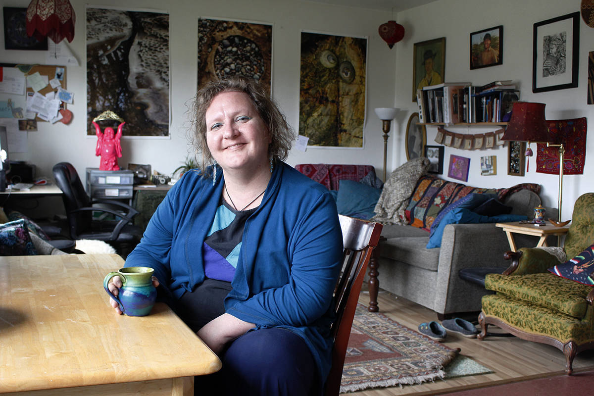Sarah Kerr sits in her small Courtenay apartment that she has decorated in a way that fuels her mind and spirit. For the past five years, she has been undergoing treatments for Stage IV colon cancer. Photo by Jolene Rudisuela