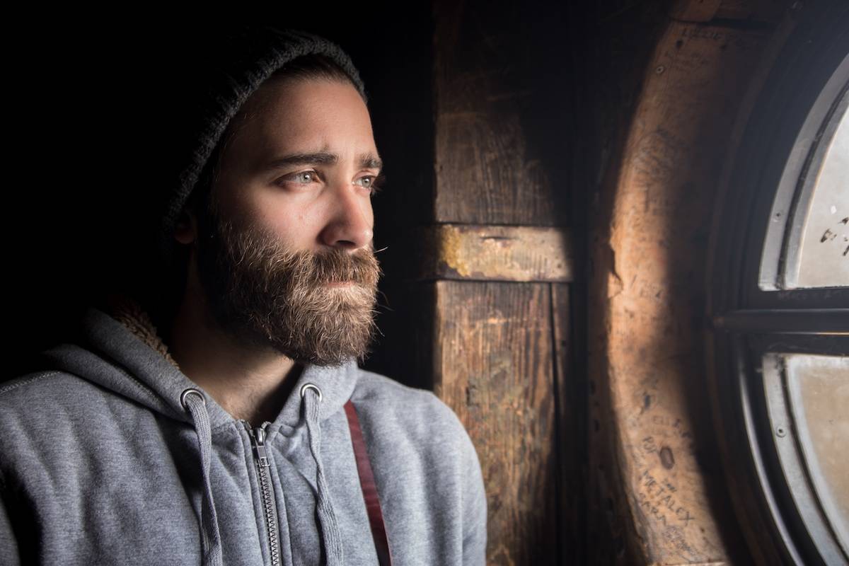 A bearded man looks wistfully out the window. A new study found beards harboured more germs than dogs’ fur. (Pixabay File)