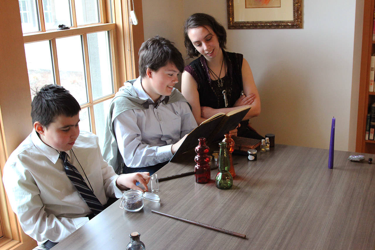 Marcus Asp (left), Olivia French and Thalia Lucie study some spells at the Alectoria School of Magic. (File contributed)