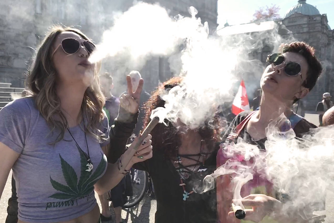 Event organizer Nikki Jackson of the Cannabis Buyers Club, Clea Maclean and Jacq Kittel celebrate 420 at the B.C. legislature. (Keri Coles/News staff)