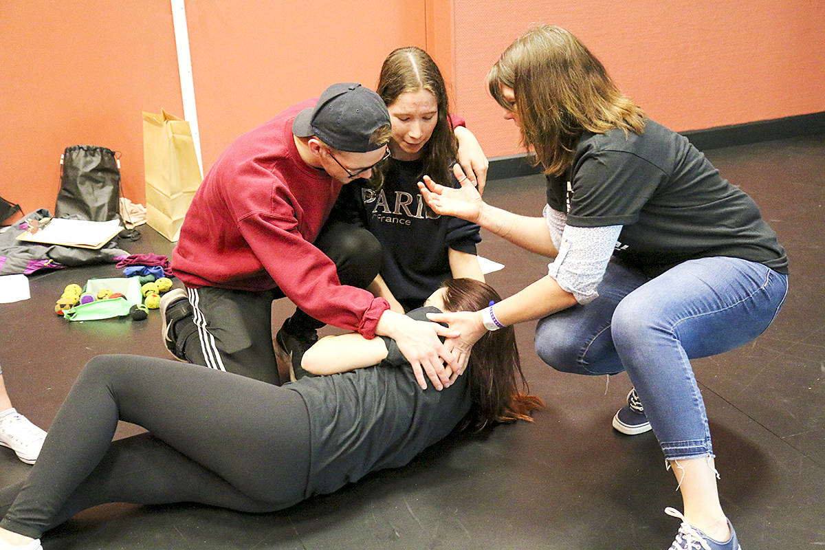 Event coordinator and Seaton Secondary drama instructor Lana O’Brien (right) leads Grade 12 student Will Oxtoby of Kelowna’s Okanagan Mission Secondary and Grade 11 Vernon Secondary product Aleena Isobe as they mourn the death of fellow Grade 11 VSS student Carmen Sampson in a quick skit of William Shakespeare’s Henry V, as part of the 18th Goodwill Shakespeare Festival. (Parker Crook/Morning Star)