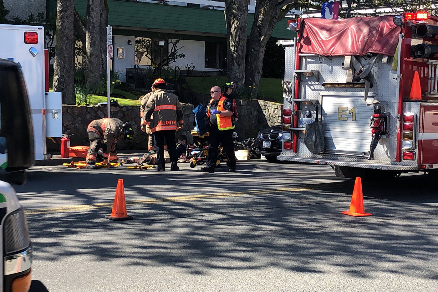 Emergency personnel tend to an injured person after a crash on Oak Bay Avenue near Elgin Road. (Travis Paterson/News Staff)
