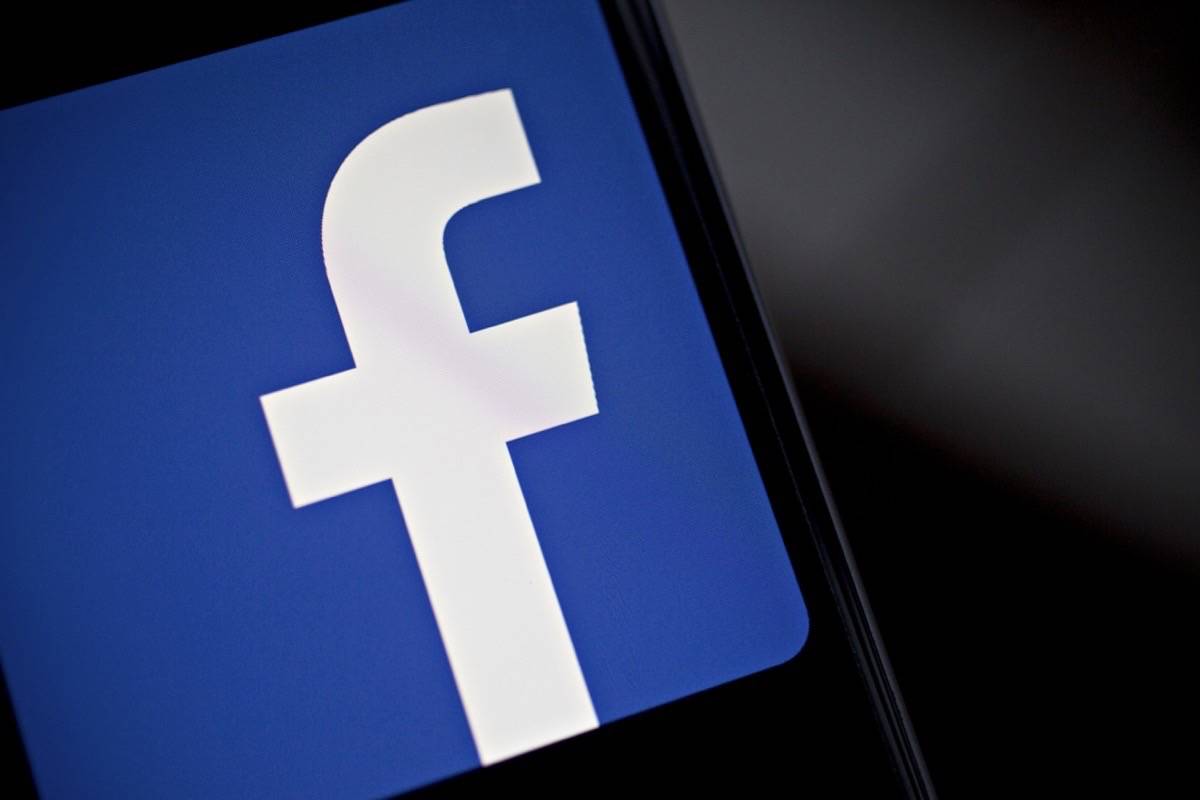 The Facebook logo is displayed on an Apple iPhone. (Bloomberg)