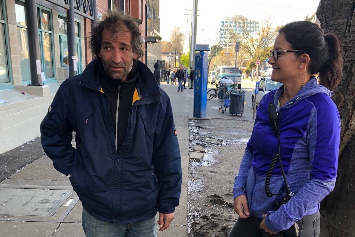 VicPD Const. Sue Hamilton talking with a client on Pandora Avenue. Hamilton says police officers joined the service to help people. (Photo courtesy of VicPD Const. Ross Smith)
