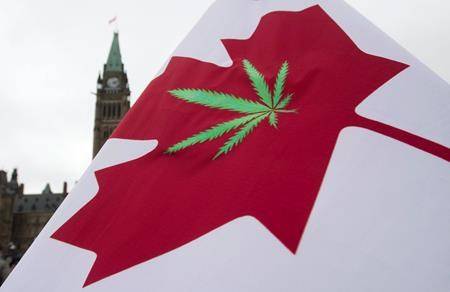 A Canadian flag with a cannabis leaf flies on Parliament Hill during the 4/20 protest, Monday, April 20, 2015 in Ottawa. Health Canada says it is changing its process for issuing cannabis licenses in a bid to reduce wait times and use the government agency’s resources more efficiently. THE CANADIAN PRESS/Adrian Wyld