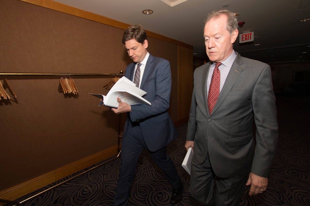 FILE – B.C. Attorney General David Eby and former RCMP officer Peter German release German’s first report on money laundering in June 2018. (B.C. government)