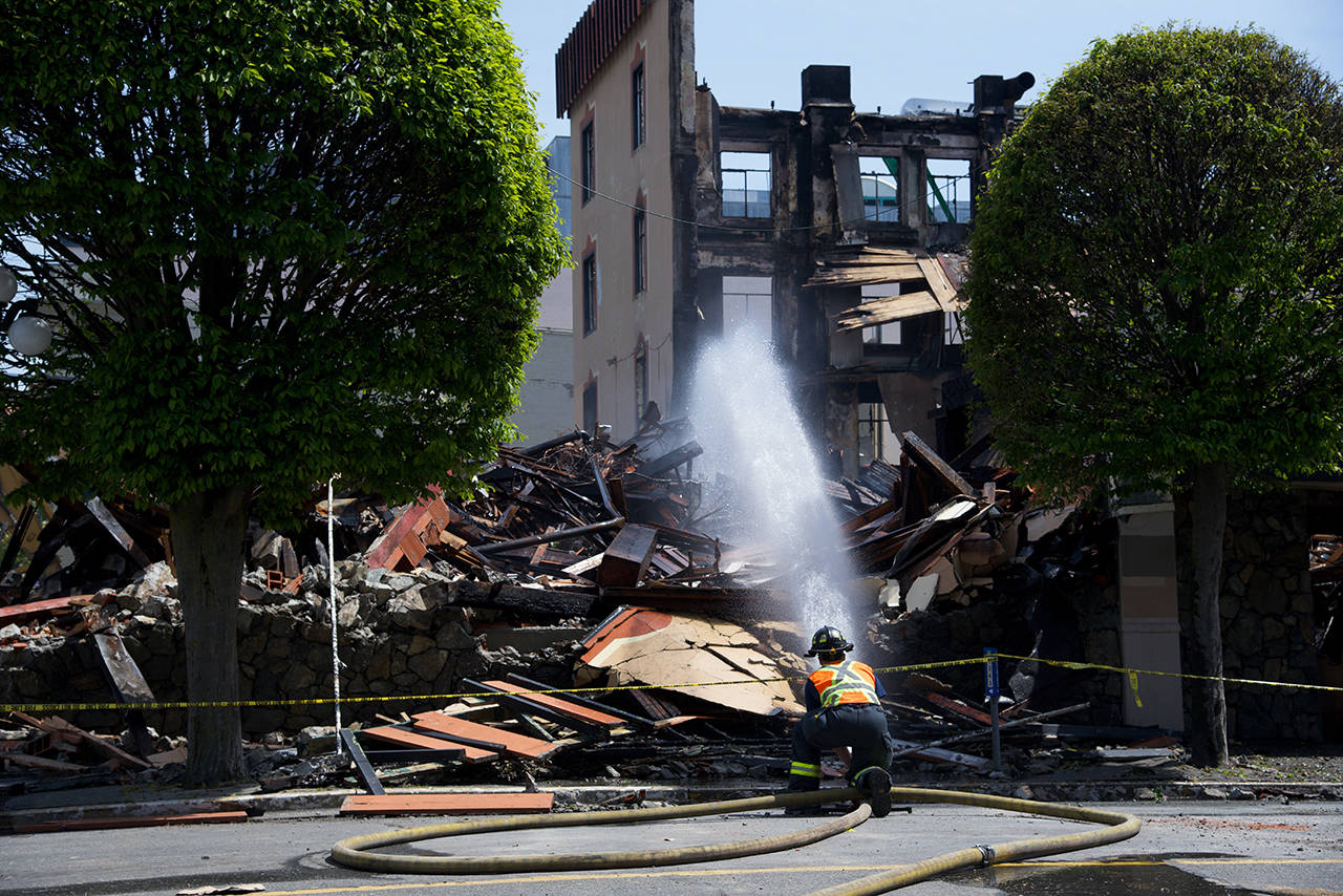 Firefighters continued to combat hot spots Thursday at the Plaza Hotel fire at 603 Pandora Ave. (Nicole Crescenzi/News Staff)