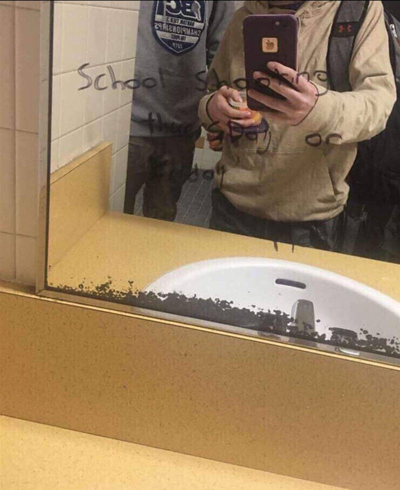 A student took a photo of the message that was written on a mirror inside the boys’ bathroom at Skeena Middle School. It reads, ‘School shooting Thursday or Friday.’ (Facebook photo)