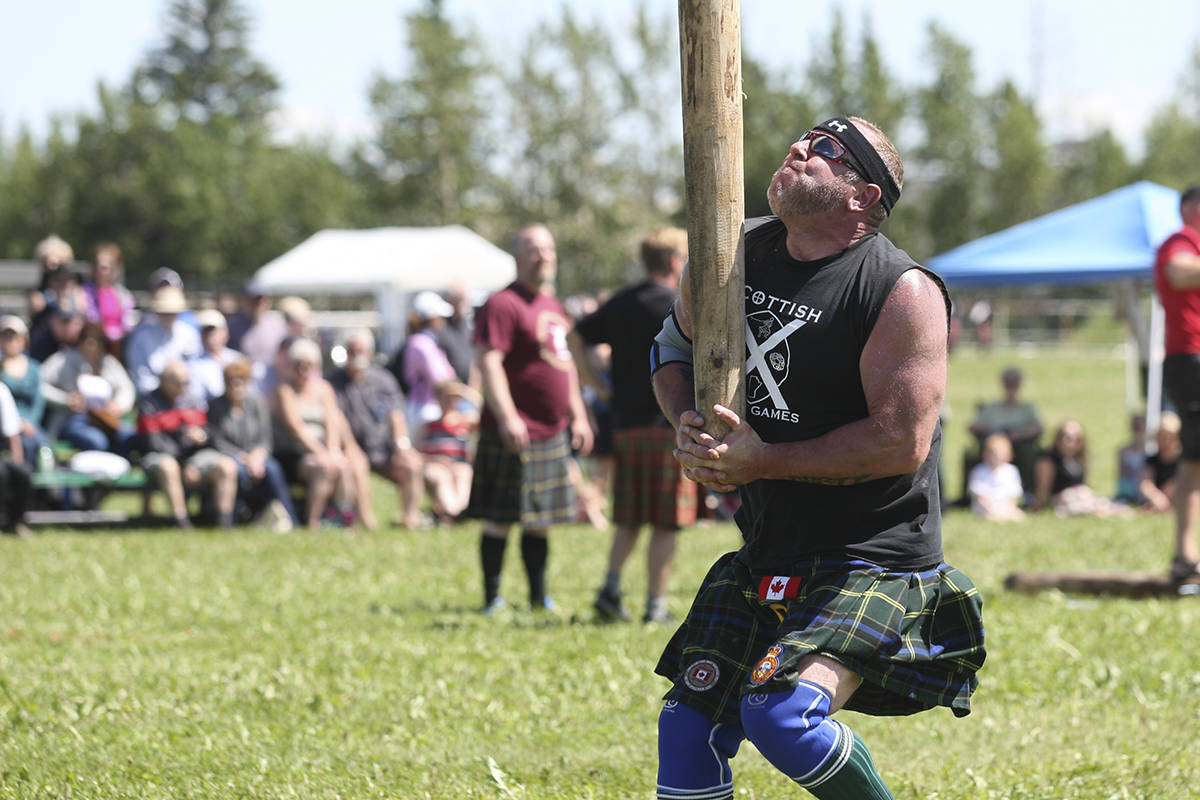 Highland Games competitor James Gerrick about to toss the caber at a Highland Games gathering. (Black Press File)