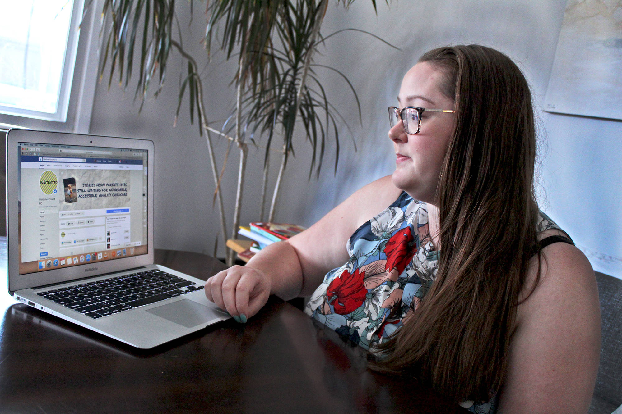 Amanda Burnett, Penticton resident and mother of two, shows the Facebook page Waitlisted Project BC. She is using the page to share stories from parents in the province who are struggling to find affordable childcare. (Jordyn Thomson - Western News)