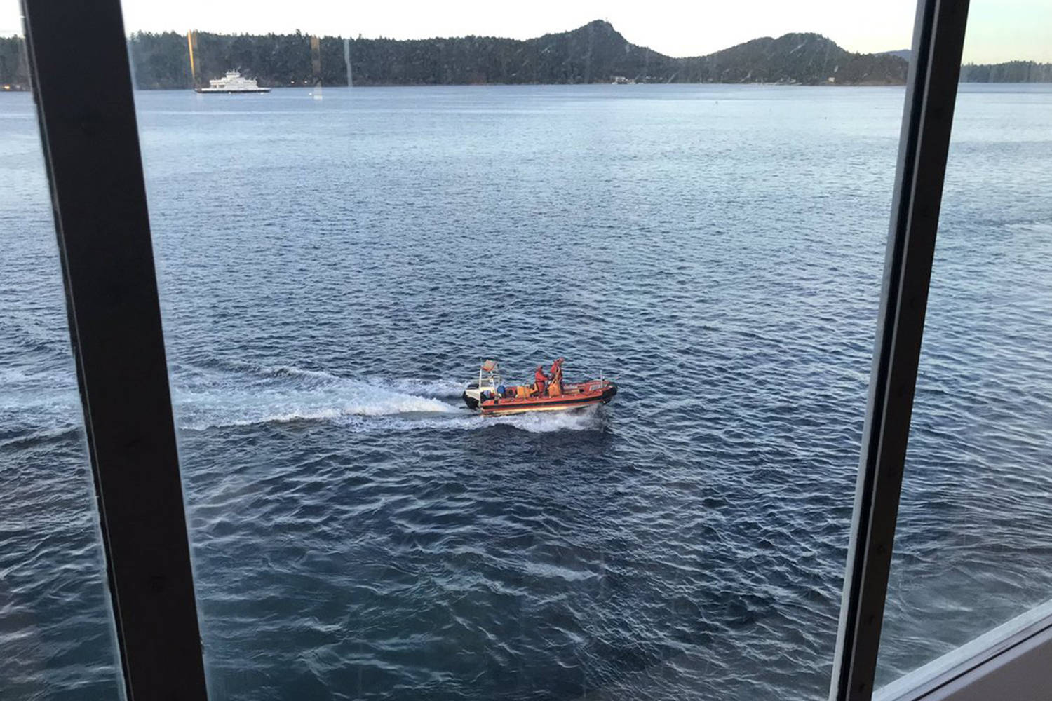 This photo shows the rescue of a man whose canoe capsized in Active Pass. (Cameron May/Twitter)
