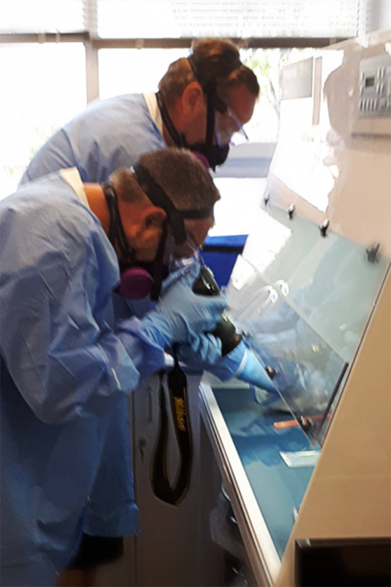 Victoria Police investigators process exhibits in the drug processing room. (Victoria Police)