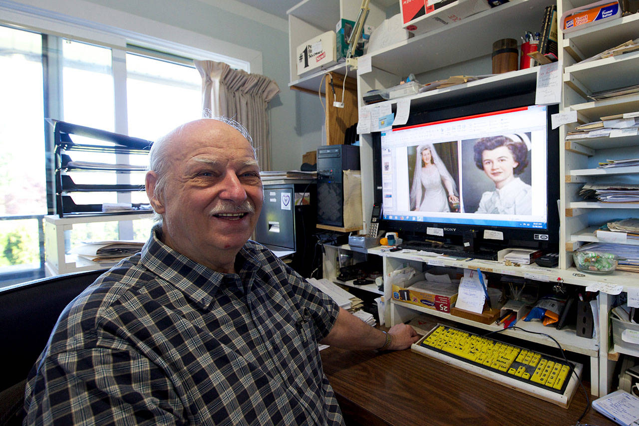 Bart Armstrong show off a digital copy of the portrait of his mother on her wedding day, as well as a portrait of his aunt. Armstrong was contacted recently by the family of the portrait artist in Belgium, which was trying to find out who the bride is. (Nicole Crescenzi/News Staff)