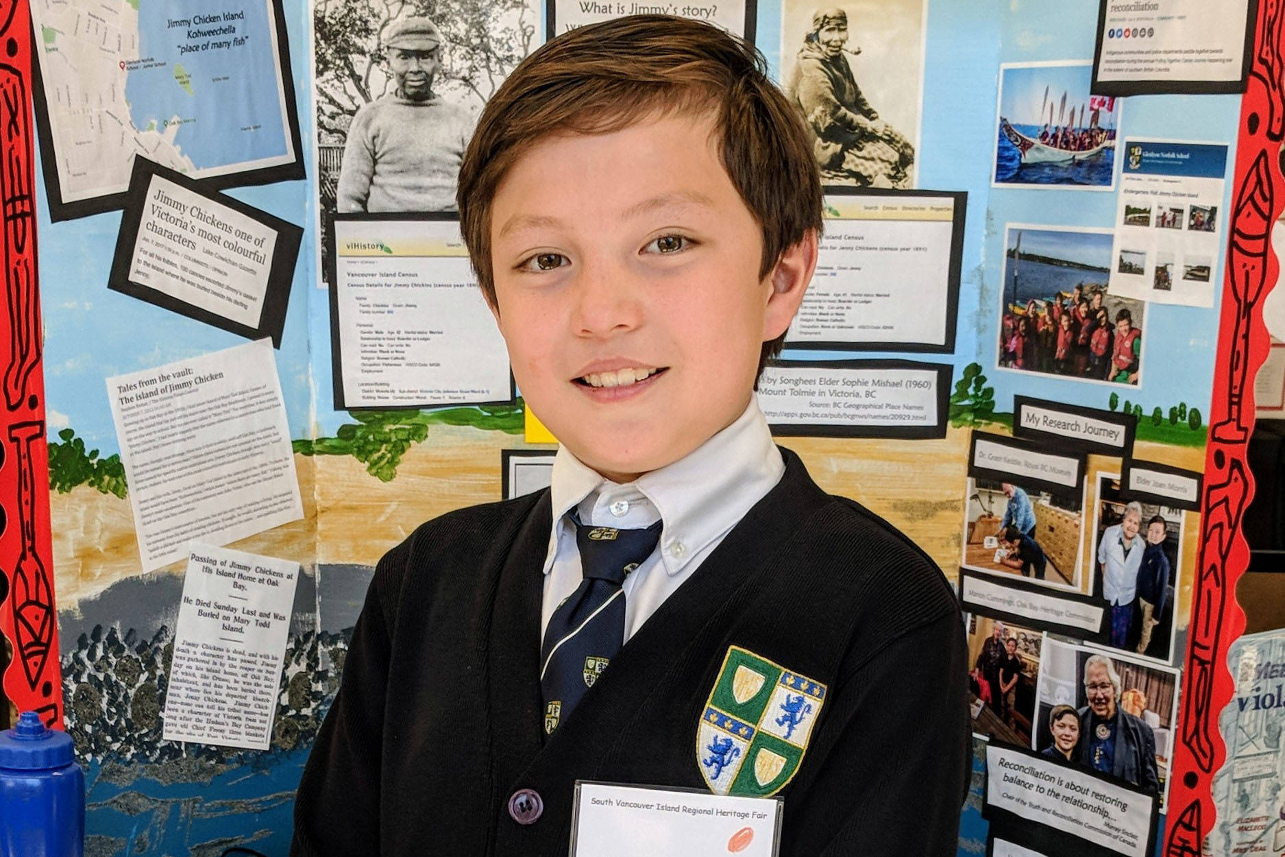 Liam Pope-Lau, an Oak Bay student, stands in front of his heritage project on Jimmy Chicken. (photo supplied)
