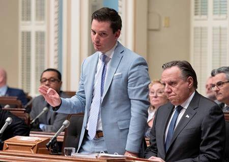 Quebec government House Leader Simon Jolin-Barrette responds to the Opposition during question period Friday, June 14, 2019 at the legislature in Quebec City. Premier Francois Legault, right, looks on. (THE CANADIAN PRESS/Jacques Boissinot)