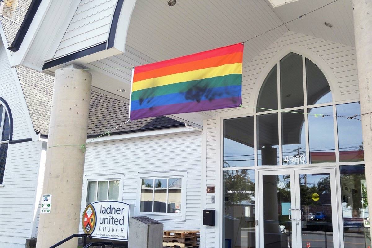 A Pride flag hanging outside Ladner United Church was found vandalized, again, on Saturday, June 15. It was the second time in 12 days the flag had been defaced. (James Smith photo)
