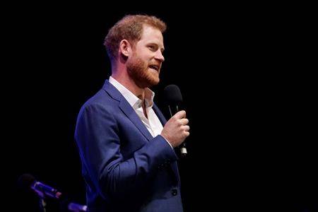 Britain’s Prince Harry speaks on stage during a concert hosted by his charity Sentebale at Hampton Court Palace, in London, Tuesday June 11, 2019. (AP Photo/Matt Dunham, Pool)