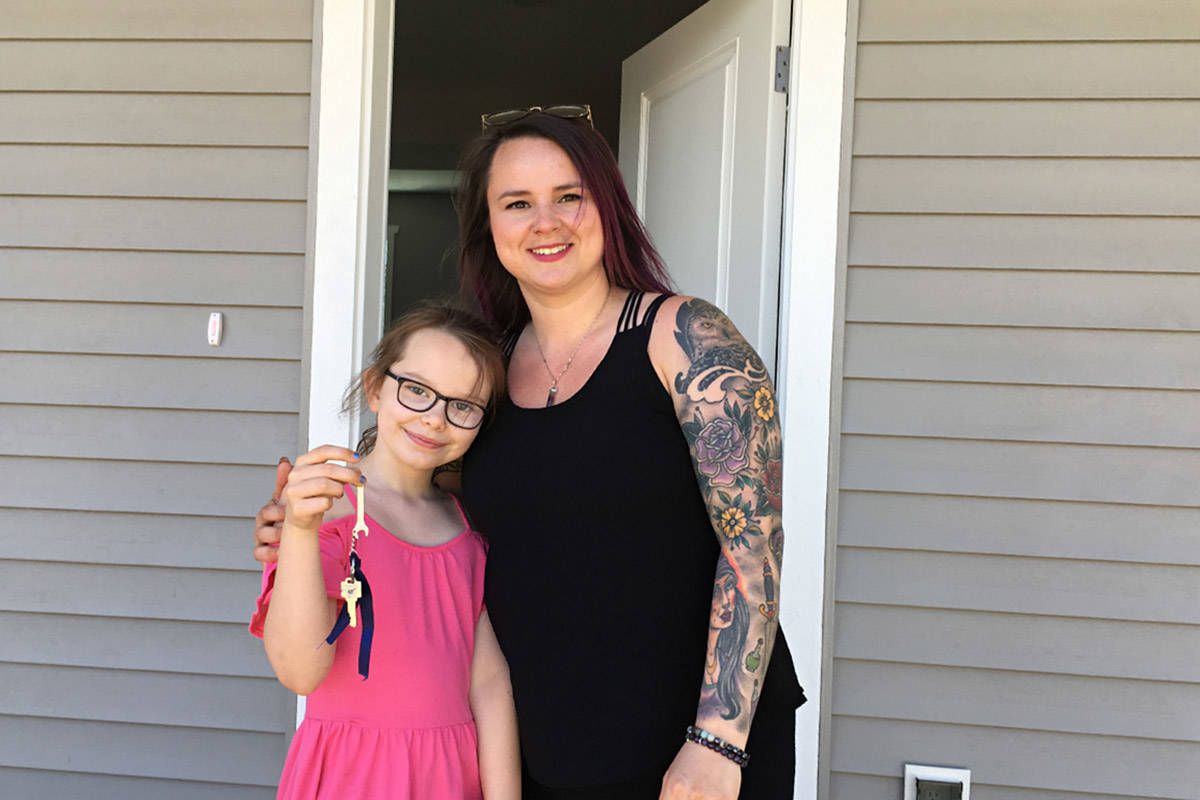 Jessica Burns and her daughter Bella, 8, are shown just after receiving keys to their new home from Habitat for Humanity on Tuesday. Photo by David Gordon Koch/Campbell River Mirror