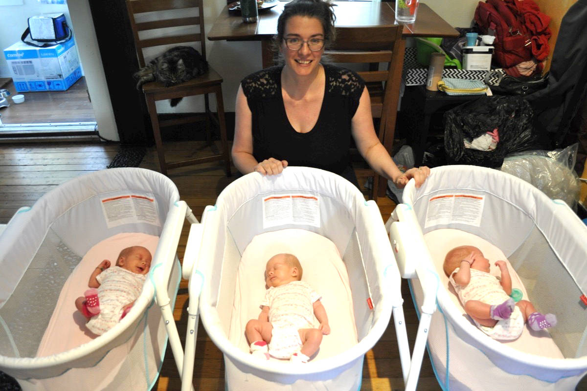Katherine van der Veen (top) and her husband Ain Baird are back in Nelson after she gave birth to identical triplets (from left) Ainsley, Olivia and Abigail. Photo: Tyler Harper