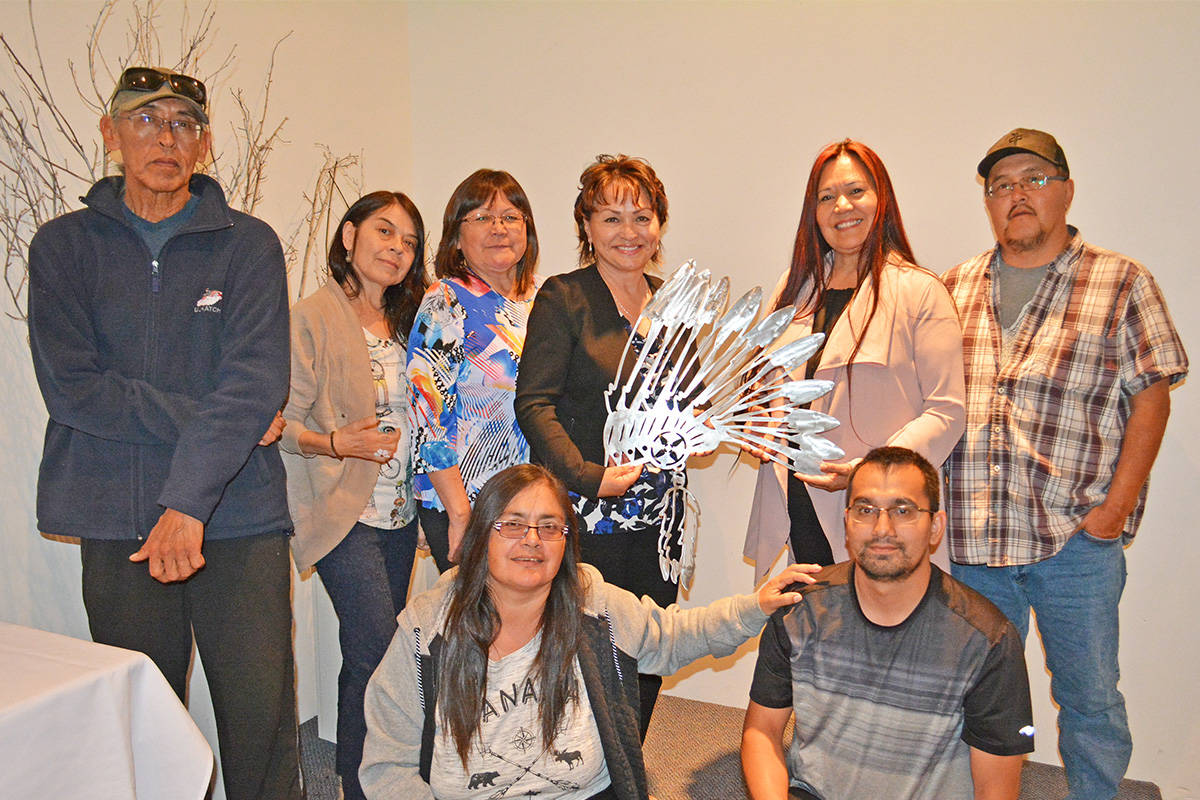 Monica Lamb-Yorski photo                                Incoming Ulkatcho First Nation Chief Lynda Price (fourth from left) presents outgoing chief Betty Cahoose (second from right) with a gift thanking her for serving as chief the last four years. Joining them are councillors Allan Louie, left, Laurie Vaughan, Mabelene Leon, and Nelson William, Stella West (left front) and outgoing councillor Tyler Sill.