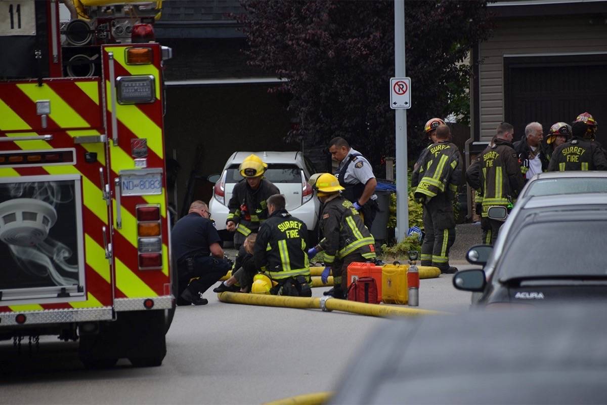 Photo: Curtis Kreklau                                Surrey firefighters and police at “suspicious” house fire in Newton on Sunday that left two children critically injured and also injured a third person.
