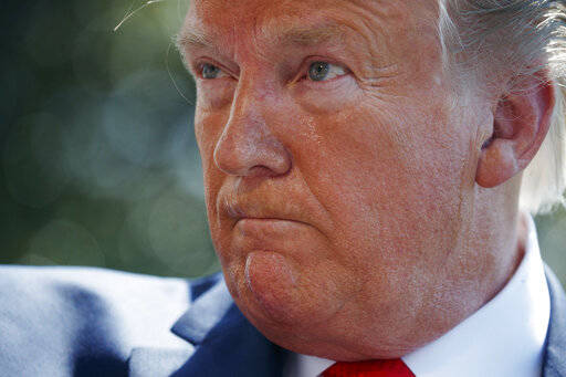 President Donald Trump listens to a question from a reporter on the South Lawn of the White House before departing for his Bedminster, N.J. golf club, Friday, July 5, 2019, in Washington. (AP Photo/Evan Vucci)