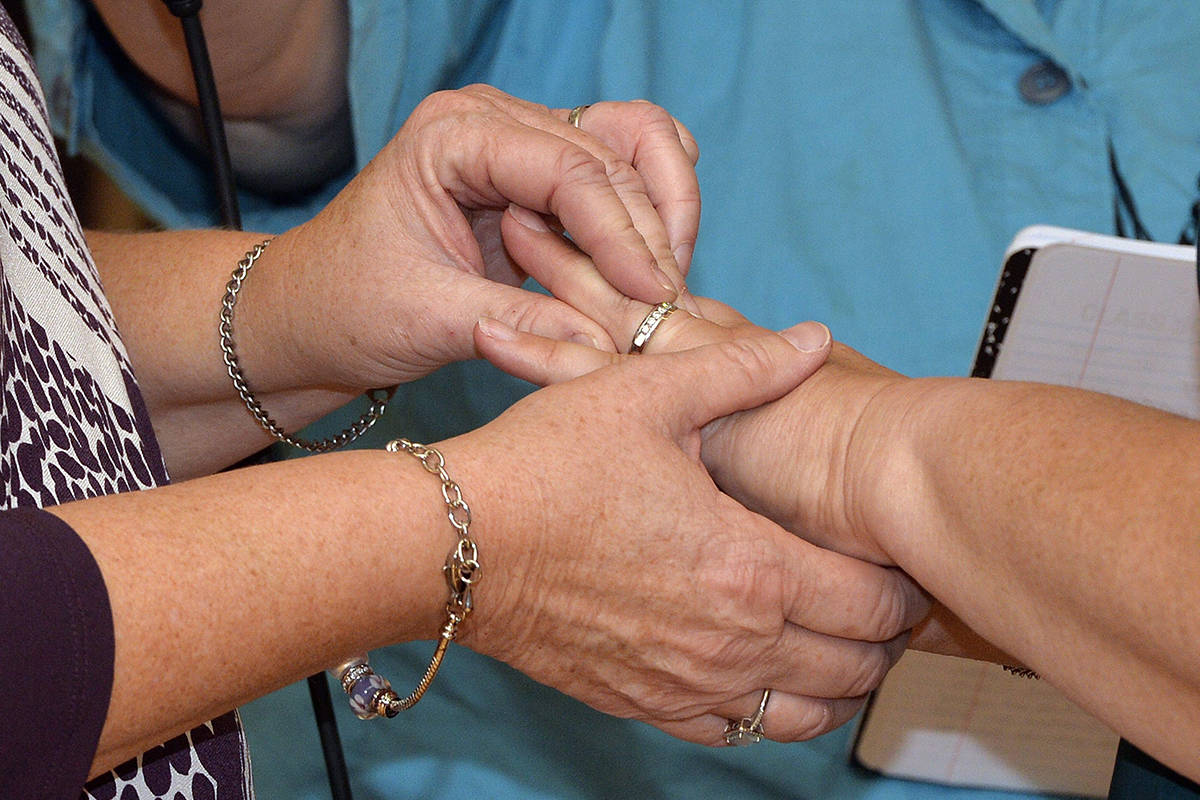 Two women place wedding bands on the finger of their partner as they renew their vows in a public ceremony on Oct. 24, 2015, in Morehead, Ky. The Anglican Church of Canada has voted down a proposal to bless same-sex marriage across the denomination, though branches of the church in each province will still be able to make up their own minds on the matter. THE CANADIAN PRESS/AP, Timothy D. Easley