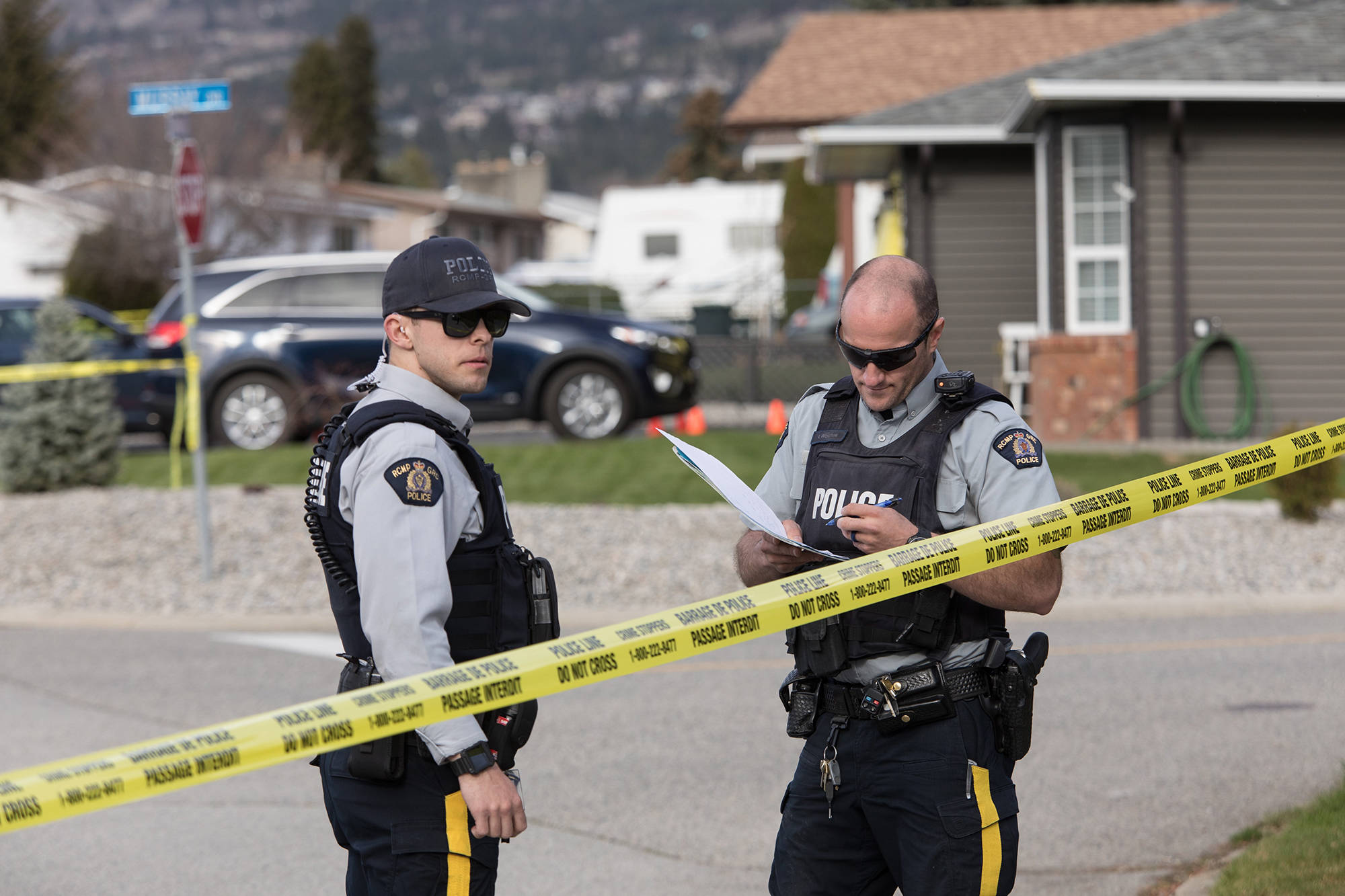 RCMP officers work outside a crime scene in Penticton, B.C., on Monday April 15, 2019. THE CANADIAN PRESS/Jeff Bassett