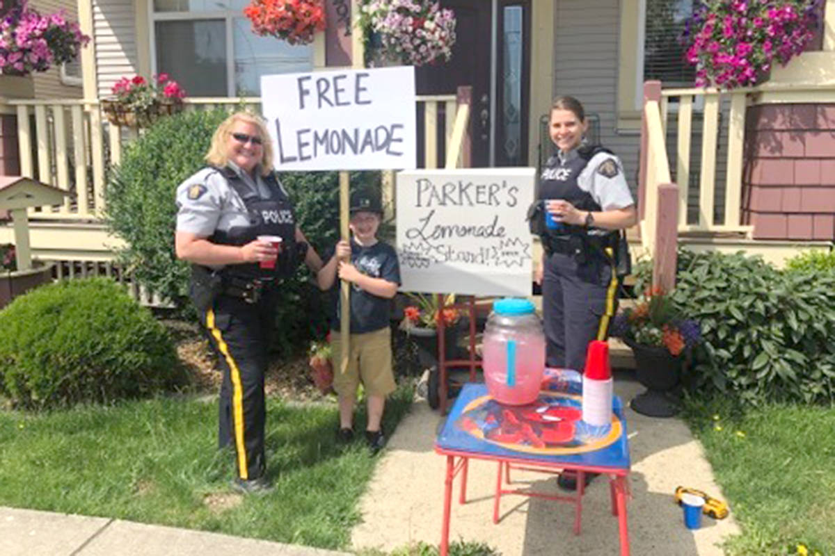 Cloverdale’s Parker Holbeche-Boyer had some special customers at his free lemonade stand on Thursday, July 18, when Surrey RCMP members and firefighters came by for a glass. (Contributed)