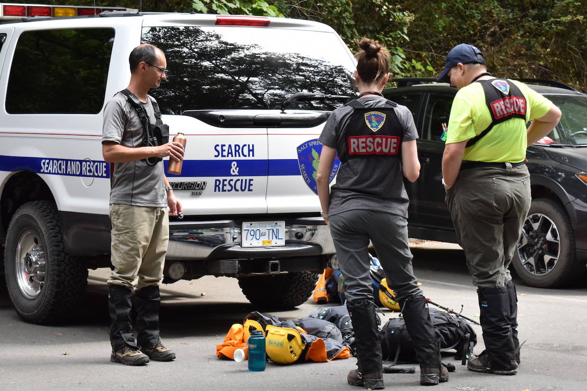 Search and Rescue specialists taking a break and re-hydrating after their shift. (Nick Murray/News Staff)