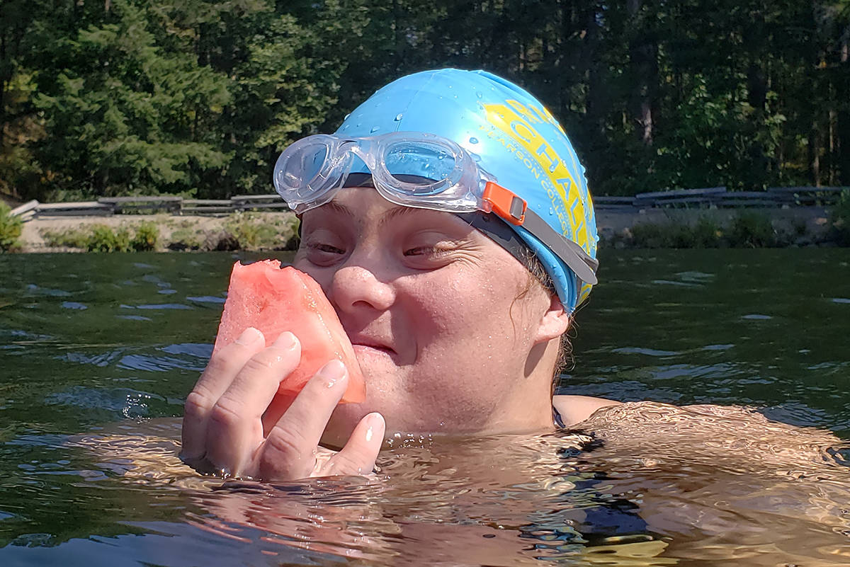Long-distance swimmer Meliah Motchman snacks on watermelon during a brief break from her five-kilometre swim around Thetis Lake on Monday. The 27-year-old may be the first Canadian with down syndrome to complete a swim of that distance. (Submitted/Susan Simmons)