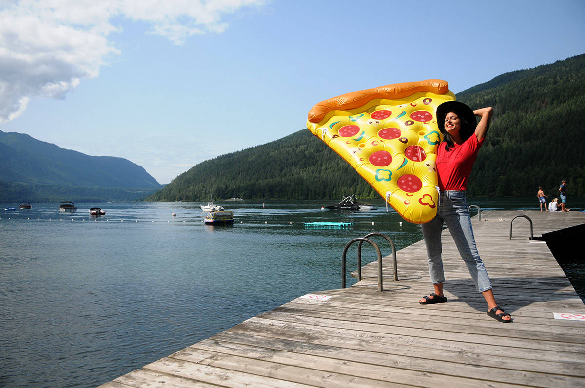 Danielle McTaggart started to float on Cultus Lake for 12 hours on this giant slice of pizza to on August 8 help raise money to send girls to school in Sierra Leone. The Cultus Lake Park Board has threatened to fine her for doing so without permits in violation of bylaws. (Jenna Hauck/ The Progress)