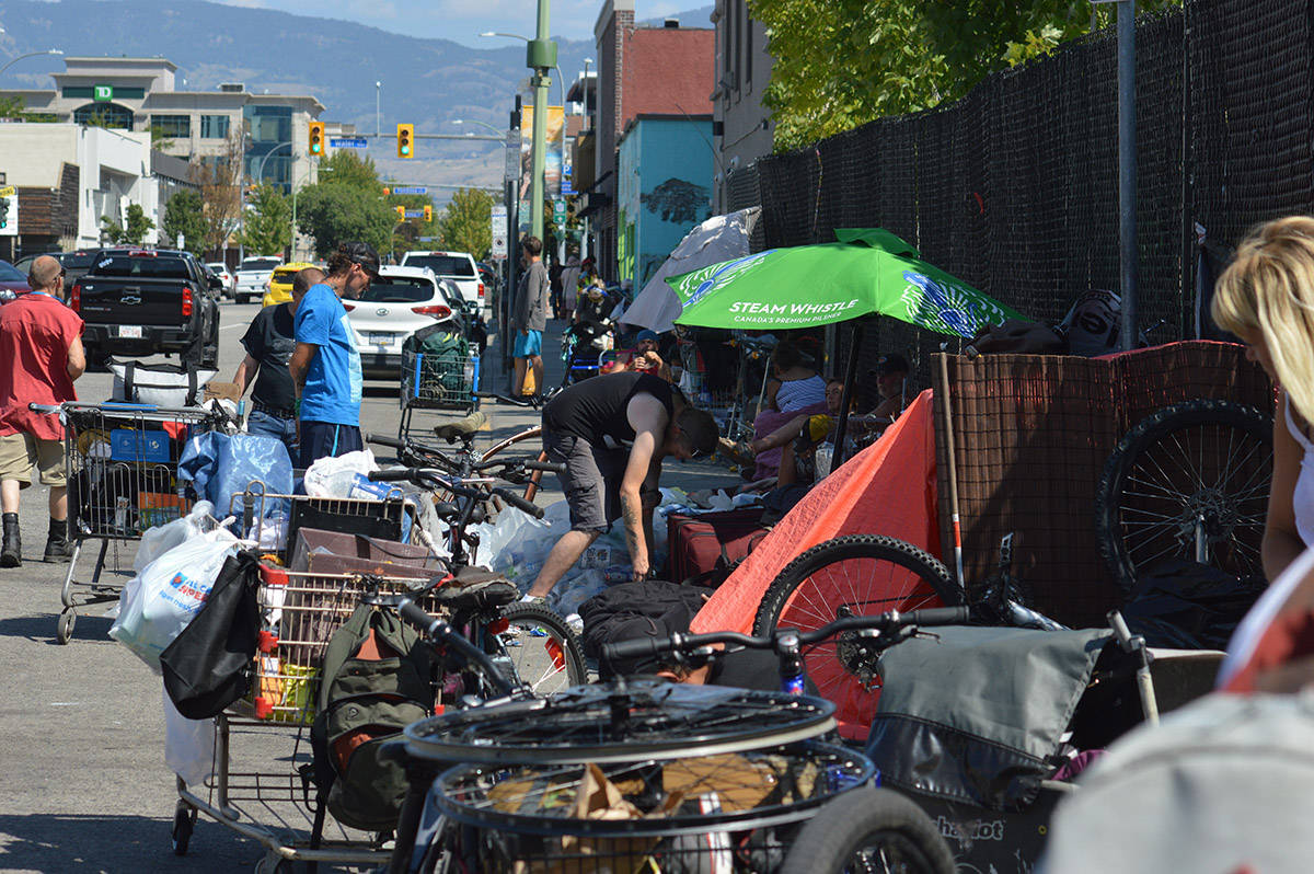 The people on Leon Avenue go about their day fixing bikes, tidying up their living space and pushing shopping carts from one area to the next. (David Venn - Capital News)